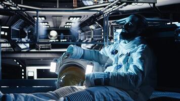Unhappy cosmonaut sighs, having mental health affected by prolonged solitude. Depressed astronaut sits on orbit station floor in silence after weeks without contact in isolated space habitat photo
