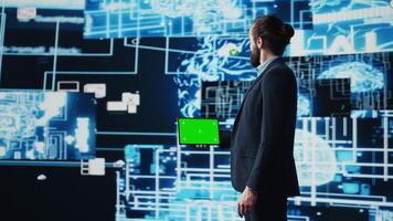 Business manager uses mockup screen next to AI neural networks, working with machine learning and cloud computing systems. Young man implementing artificial intelligence. Camera B. photo
