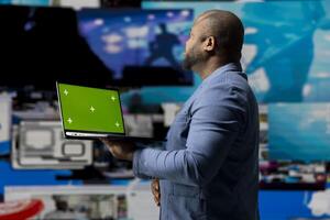 Modern black interface user holding a device with green screen with digital system of screens and apps, highlighting the integration of AI and fintech. Communication and content creation. photo