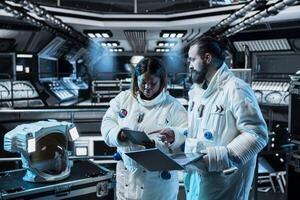 Astronauts monitoring life support systems, conducting safety checks during long distance space travel. Starship colleagues verifying navigation coordinates during cosmic journey photo