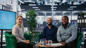 Group of diverse business partners meeting for a new contract negotiation, working together for a global development. Associates analyzing insights and annual reports in a briefing. Camera A. photo