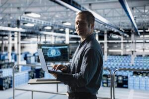 Portrait of smiling engineer in AI data center monitoring error logs for debugging processes. Cheerful employee in server farm reviewing code for artificial intelligence based automation scripts photo