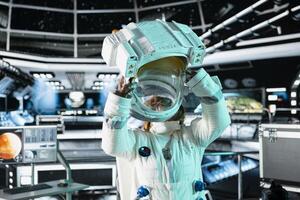 Female scientist putting on helmet in cutting edge spaceship doing cosmic voyage in solar system. African american astronaut researcher putting on cosmonaut gear aboard orbital station photo