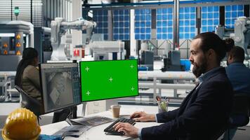 Sustainability expert evaluates solar panel systems next to mockup, working on production line in a modern industrial facility. Guiding operations toward clean energy efficiency. Camera A. photo
