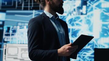 Tech savvy administrator reviewing AI brain programming on a tablet, exploring algorithmic thinking and deep learning through neural networks system. Artificial intelligence coding. Camera A. photo