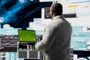 Black executive manager studying copy space screen with data insight for business growth, surrounded by virtual graphs and forecasting models. Financial performance and decision making. photo