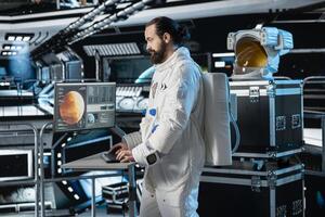 Cosmonaut in orbital station looking at monitor, preparing for mission launch to Mars. Man working on spaceship looking at display, navigating orbital trajectory to red planet photo