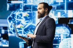 Male IT expert interacting with a digital AI neural network to symbolize machine learning and algorithmic thinking for smart tech innovation and future development strategy. Data science. photo