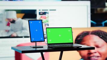 Green screen laptop in front of multimedia collage reflecting entertainment concept. Mockup notebook and digital interface showing gaming clips, cooking shows and other internet media photo