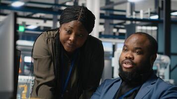 Black team of engineers technicians share ideas in a solar panel factory, reviewing blueprints and sharing ideas to enhance renewable energy production and sustainable innovation. Camera B. photo