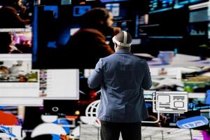 African american influencer using virtual reality glasses in mobile apps world, examining cloud data, visual content and emphasizing presence across tech platforms and social networks. photo
