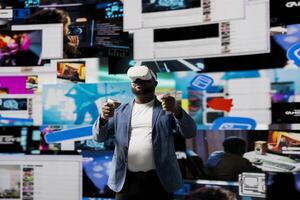 African american tech user immersed in visual environment with VR glasses, representing communication, e commerce and online entertainment. Social networking powered by digital tools. photo
