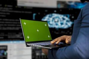 Young engineer works on binary code with copy space on laptop, reflecting the mindset of a tech world. Innovation hub with programming languages and development tools, coding life. photo