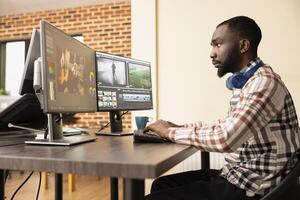 African american digital filmmaker applying color grading and creative editing to multimedia footage. Black male content creator refining montage with professional post production software. photo