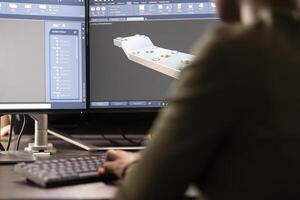 Selective focus of african american skilled 3D modeler using advanced software to refine geometry. Graphics industry female expert sitting at desk with computer, optimizing a project design. photo
