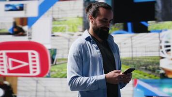 Modern online lifestyle of a young man checking real time notifications, enjoying interaction with followers and posting creative content in a social network environment. Camera A. photo