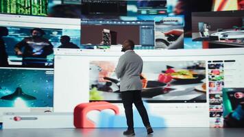 Delighted man entering world of online media, enjoying access to thousands of streaming videos. Ecstatic user surrounded by previews highlighting diverse internet content, camera A photo