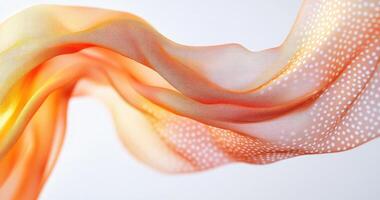 Orange-toned flowing fabric with dotted pattern photo