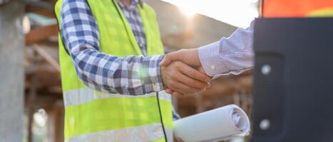 Construction team hands shaking greeting start up plan new project contract in office center at construction site, industry ,architecture, partner, teamwork, agreement, property, contact photo