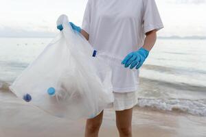 Save ocean. pick up trash garbage at the beach and plastic bottles are difficult decompose prevent harm aquatic life. Earth, Environment, Greening planet, reduce global warming, Save world photo