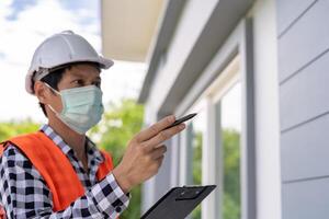 inspector or engineer inspec construction and quality assurance new house. Engineers or architects or contactor work to build the house before handing it over to the homeowner photo