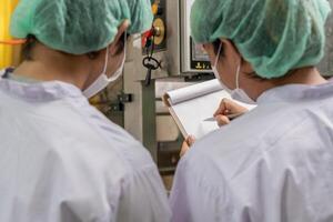 inspector food beverages technician inspection about quality control food or beverages before send product to the customer. Production leader recheck ingredient and productivity. photo