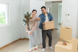 Moving house, Husband wife hold box and forniture for new apartment or home, inside the room was a cardboard box containing personal belongings and furniture. move in the house or condominium photo