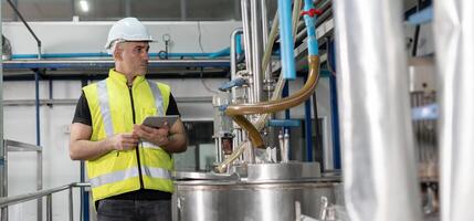 Engineers managers wearing safety helmet inspect the machines in the production line. Utility inspector check machine and test the system to meet the standard. machine, maintenance. photo