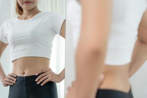Women showing results diet. Beautiful shape. female look mirror for check shape body have a reduced waist size after under going a weight loss corse. balance, control, routines, exercise. photo