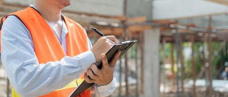 inspector or engineer construction and quality assurance new house using a checklist. Engineers or architects or contactor work to build the house before handing it over to the homeowner photo