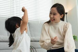 Mother day. Happy mother playing with the little girl. Funny family is happy and excited in the house. mother and daughter have fun spending time together. holiday, weekend, IQ, EQ, meditation photo