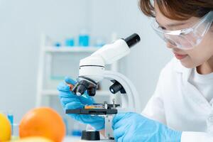 Scientist check chemical food residues in laboratory. Control experts inspect quality of fruits, vegetables. lab, hazards, ROHs, find prohibited substances, contaminate, Microscope, Microbiologist, photo