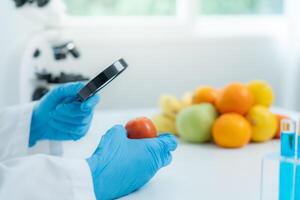 Scientist use magnifying glass to check physical occur from chemical on fruit and vegetable residues in laboratory. inspect the concentration of chemical residues, find prohibited substances. photo