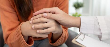 psychiatrist hold hand support each while discussing family issues. doctor encourages and empathy woman suffers depression. psychological, save divorce, Hand in hand together trust, care. photo