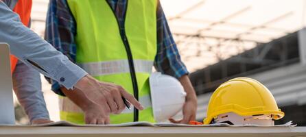 inspector inspecting construction and quality assurance new house using a blue print. Engineer or architects or contactor work to build the house before handing it over to the homeowner photo