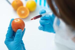 Scientist check chemical residues in laboratory. Control experts inspect quality of fruit, scientists inject chemicals into apples for experiments, hazards, prohibited substance, contaminate photo