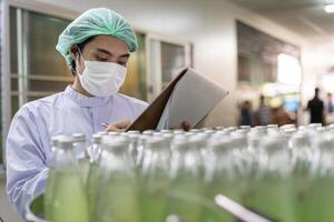 quality supervisor or food or beverages technician inspection about condition control food or beverages before send product to the customer. Production leader recheck machine productivity. photo