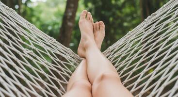 A woman's legs are in a hammock photo