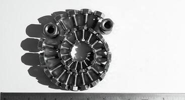 Bolts and Nuts Arranged in Spiral Pattern with Ruler photo
