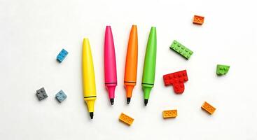 A group of colorful pens and a piece of paper photo