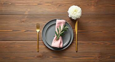 A plate with a napkin and a fork on a wooden table photo