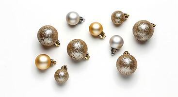 A group of gold and silver ornaments on a white surface photo