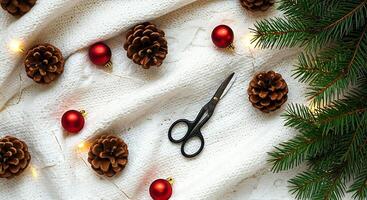 A pair of scissors, pine cones and christmas decorations on a white background photo