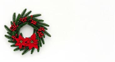 A wreath with poinsettia and berries on a white background photo