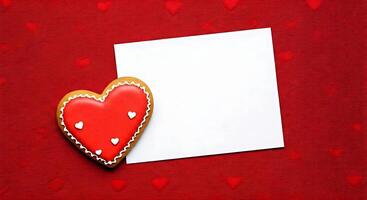 A cookie with a heart shape on a red background photo