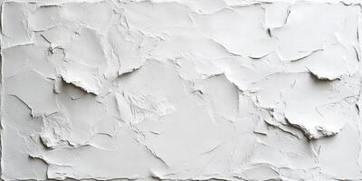 Weathered white plaster wall displaying extensive cracking, paint peeling, revealing textured distressed surface with structural deterioration photo