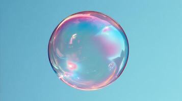 Iridescent soap bubble floating against clear blue sky background photo