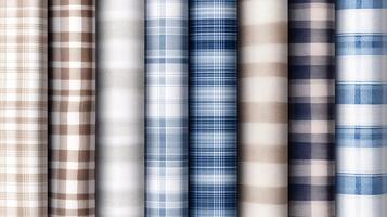 Collection of plaid fabric rolls in various colors and patterns arranged neatly in a fabric store for quilting, sewing, and crafting enthusiasts photo