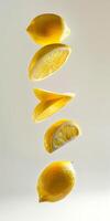Suspended lemons showcase their juicy, bright yellow flesh against a soft background, highlighting their appeal photo