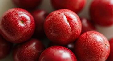 Close-up of vibrant red plums with water droplets, a fresh and juicy fruit selection photo